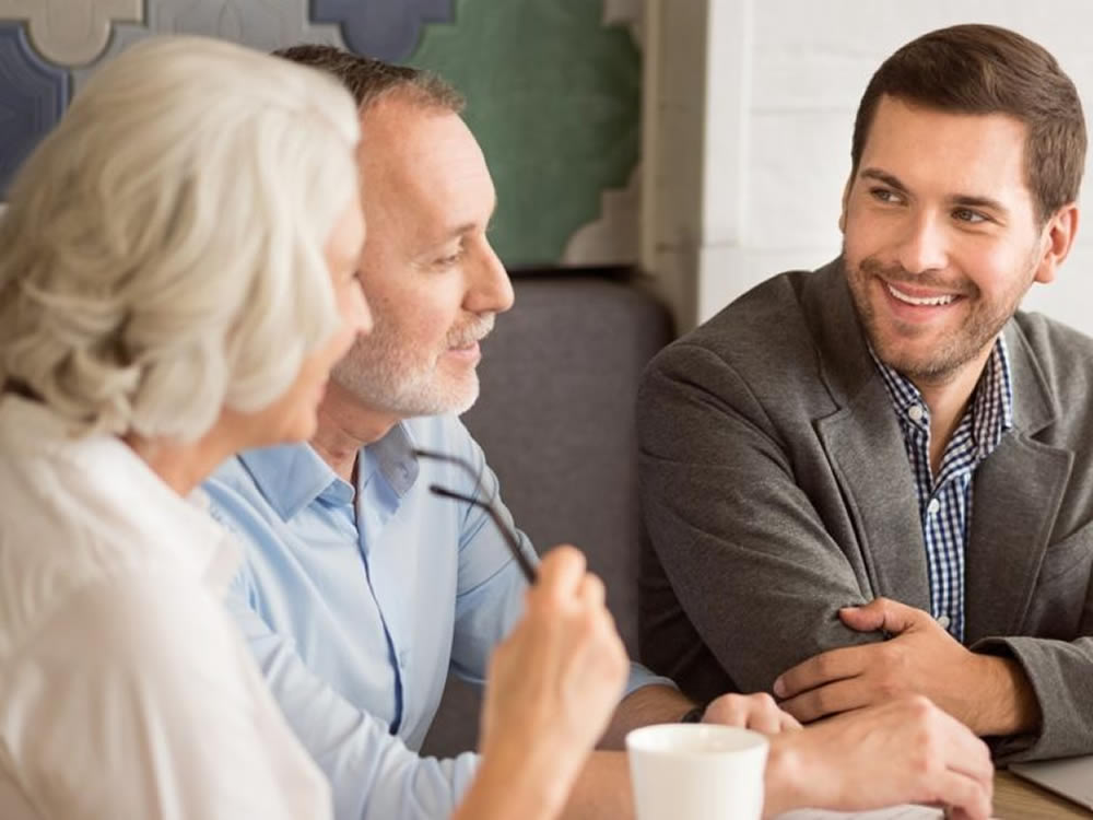 people sitting and discussing while having a cup of coffee