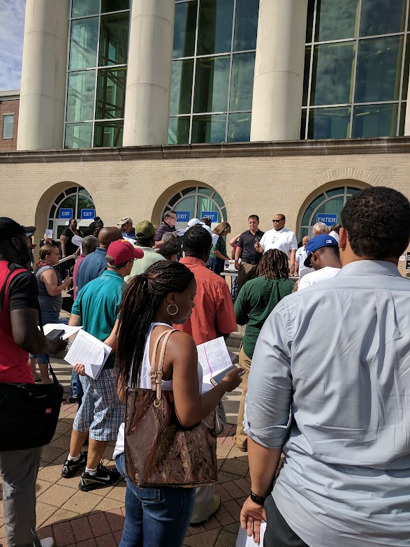 students waiting along their documents