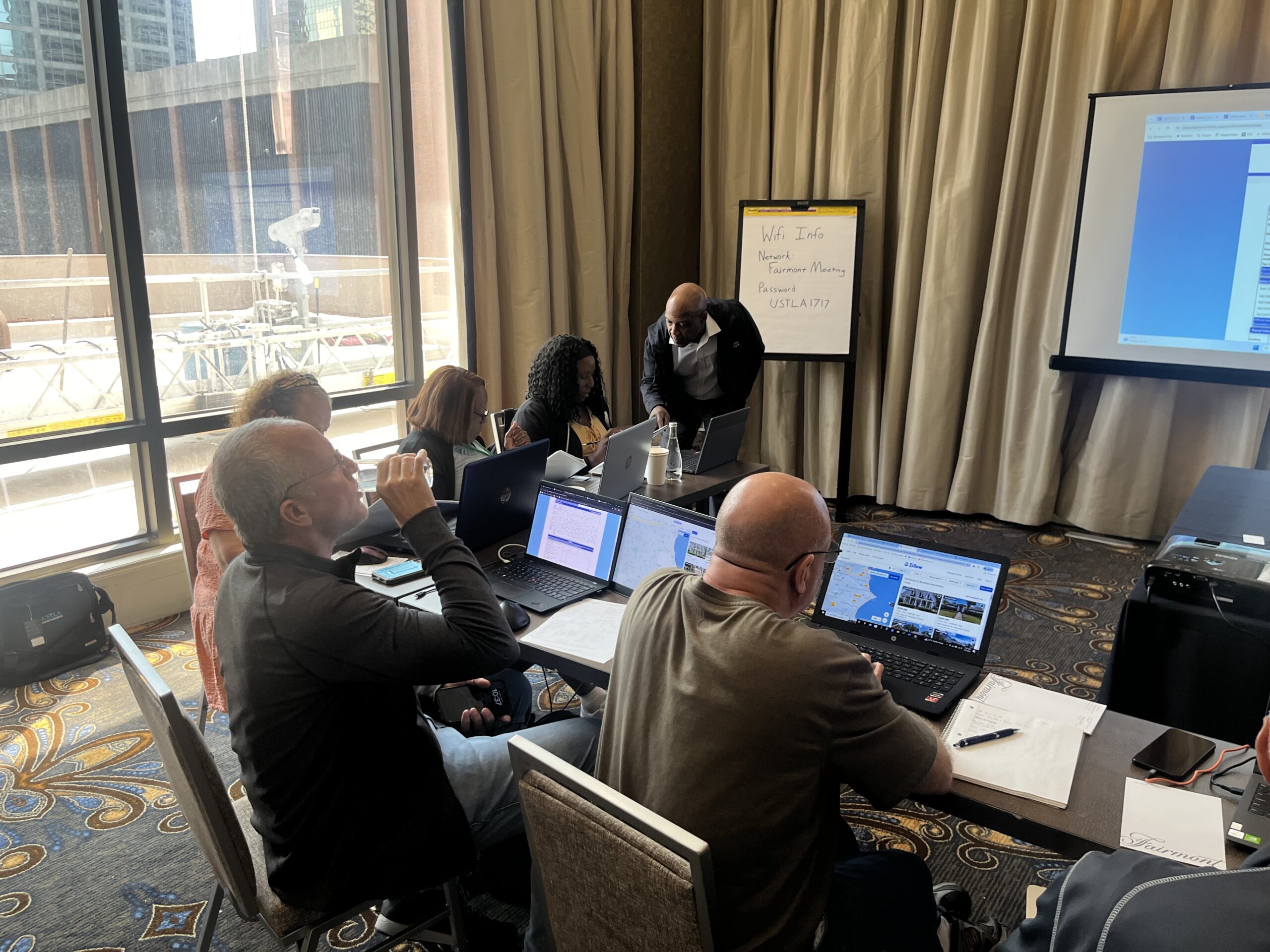 Making notes on their laptops